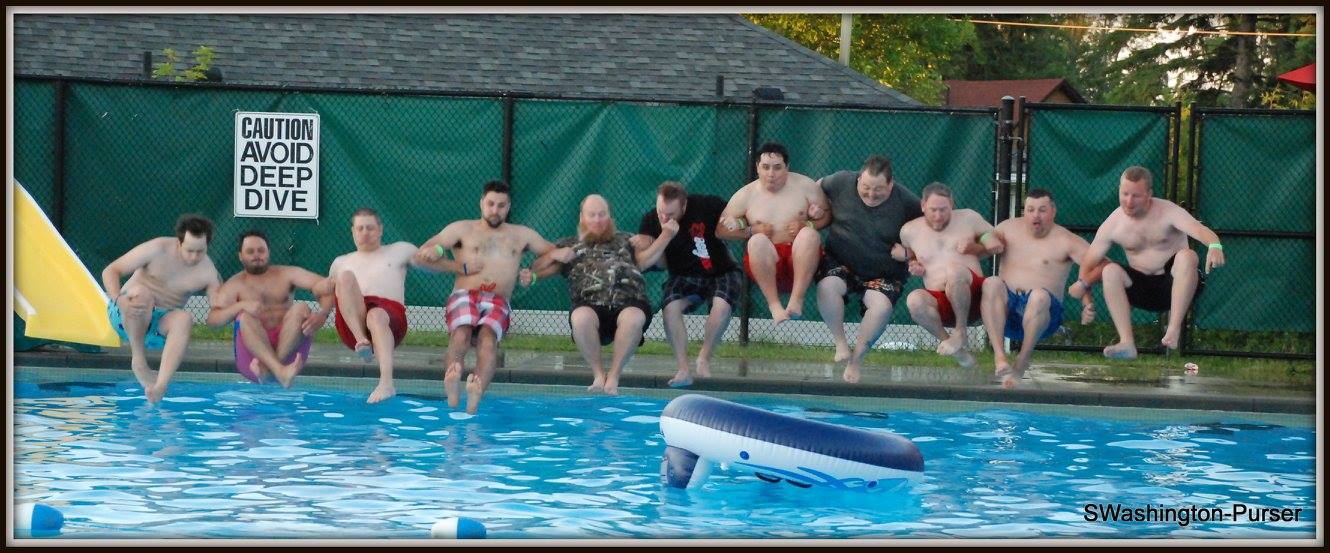 Male Faculty doing a group canon ball into the pool